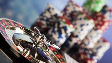 Live Bandar Poker dealer at table with card deck and betting chips